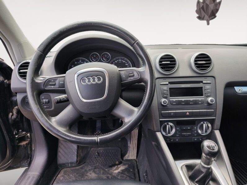 Audi A3 2009 interior view showcasing steering wheel, dashboard controls, and gear shift, highlighting sporty design and luxury features.