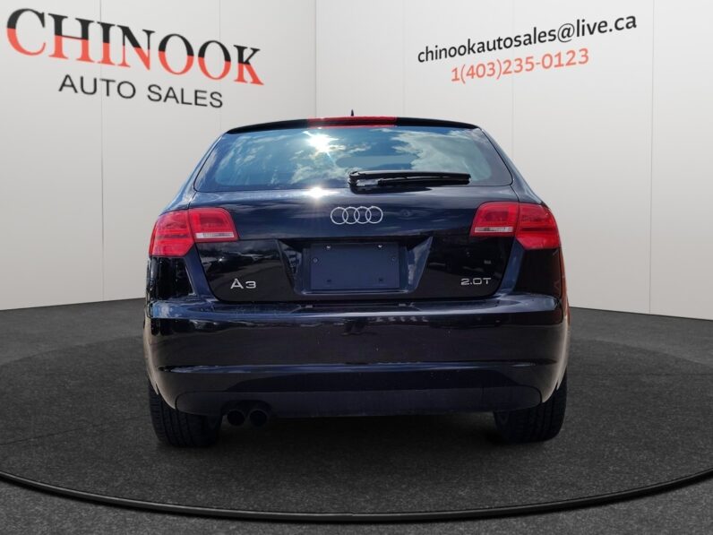 2009 Audi A3 rear view showcasing sleek design, "A3" and "2.0T" badges, and Chinook Auto Sales branding in the background.