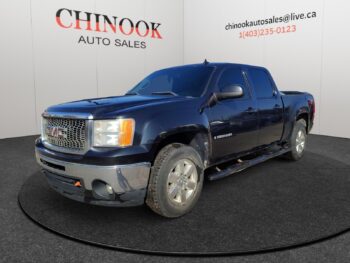 GMC Sierra 1500 pickup truck in blue, showcased at Chinook Auto Sales, featuring a modern design and prominent front grille.