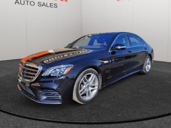 Mercedes-Benz S-Class luxury sedan in a showroom setting, featuring sleek design and polished finish, promoting Chinook Auto Sales' vehicle inventory.
