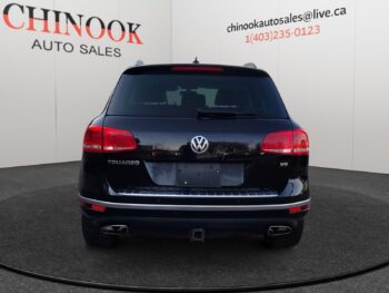 Volkswagen Touareg rear view showcasing dealership branding and features, highlighting automatic transmission and SUV design.