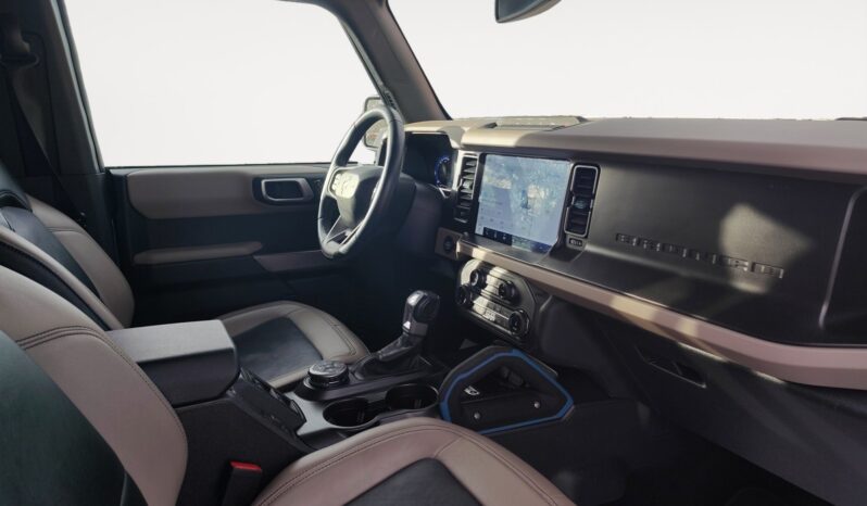 2022 Ford Bronco Wildtrak Sasquatch interior showcasing modern dashboard, touchscreen display, and seating, emphasizing its SUV features and off-road readiness.