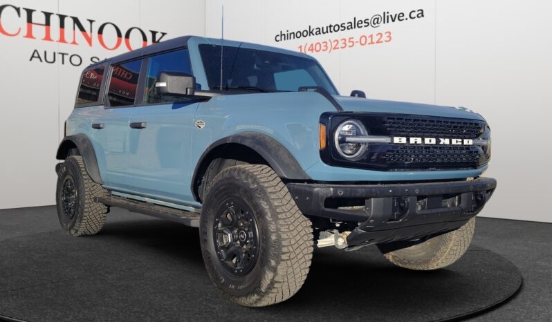 2022 Ford Bronco Wildtrak Sasquatch in blue, showcasing off-road tires and rugged design, featured at Chinook Auto Sales for CAD $49,998.
