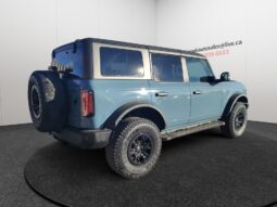 2022 Ford Bronco Wildtrak Sasquatch in blue, showcasing rear and right side, equipped for off-road adventures, with rugged tires and distinctive styling, highlighting used SUV features for sale at Chinook Auto Sales.