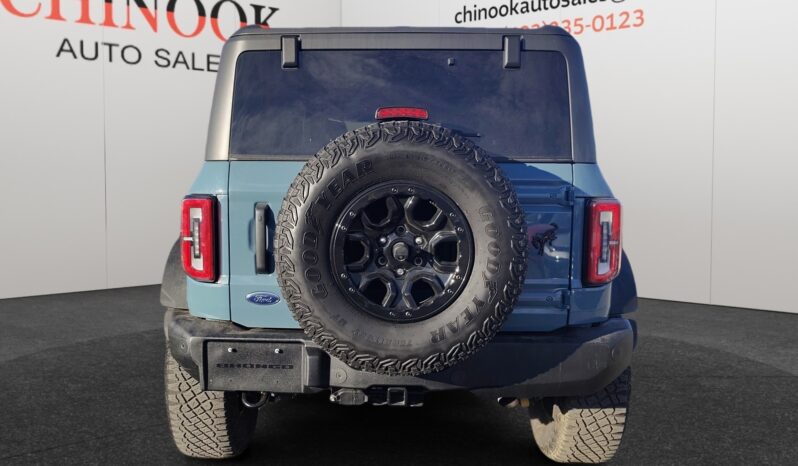 2022 Ford Bronco Wildtrak Sasquatch in blue, rear view showcasing spare tire and off-road features, displayed at Chinook Auto Sales.