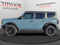 2022 Ford Bronco Wildtrak Sasquatch in blue, side view, showcasing off-road capabilities, displayed at Chinook Auto Sales.