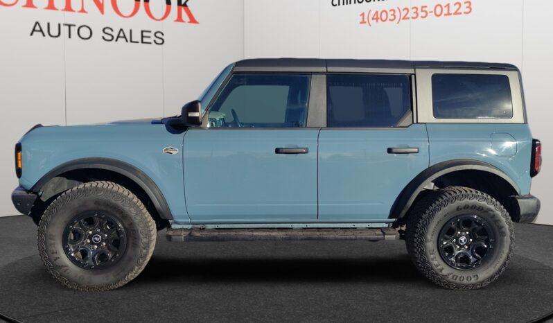 2022 Ford Bronco Wildtrak Sasquatch in blue, side view, showcasing off-road tires and bold design, displayed at Chinook Auto Sales.