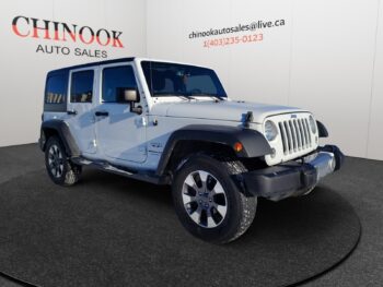 Jeep Wrangler Unlimited in silver, featuring four doors and rugged design, displayed at Chinook Auto Sales, highlighting its suitability for off-road adventures and versatility.
