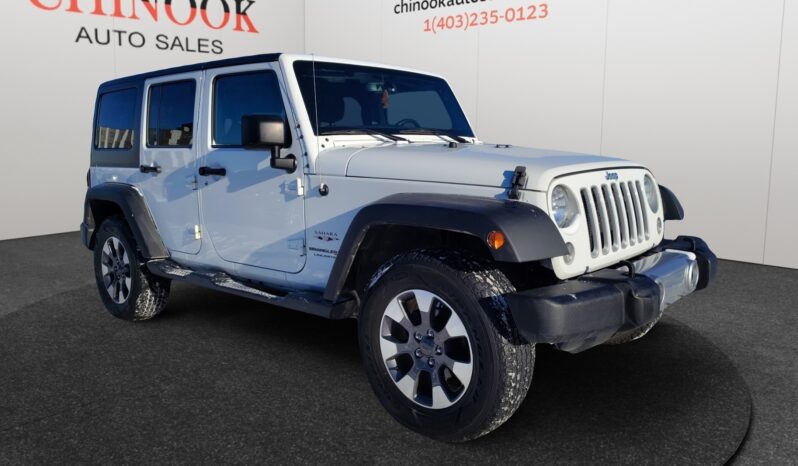 2018 Jeep Wrangler Sahara Unlimited 4&times;4 in white, showcasing front-right view, featuring rugged design and alloy wheels, displayed at Chinook Auto Sales.