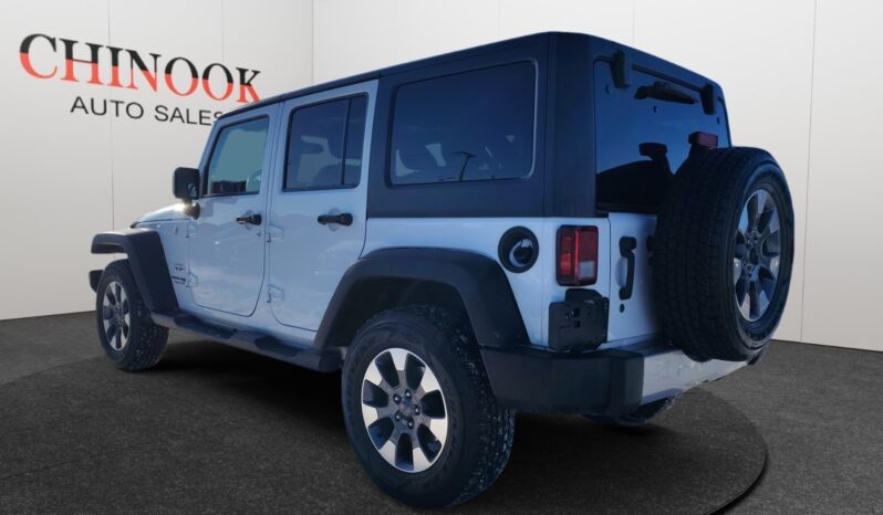 2018 Jeep Wrangler Unlimited Sahara 4&times;4 in white, showcasing rear and left side features, with Chinook Auto Sales branding in the background.