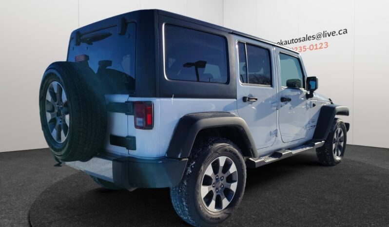 2018 Jeep Wrangler Sahara Unlimited 4&times;4 in white, showcasing rear and side view, highlighting its rugged design and off-road capabilities, available at Chinook Auto Sales for CAD $25,998.