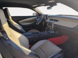 Interior view of a 2014 Chevrolet Camaro 2LT showcasing beige leather seats, modern dashboard, and sporty design elements, emphasizing luxury and performance.