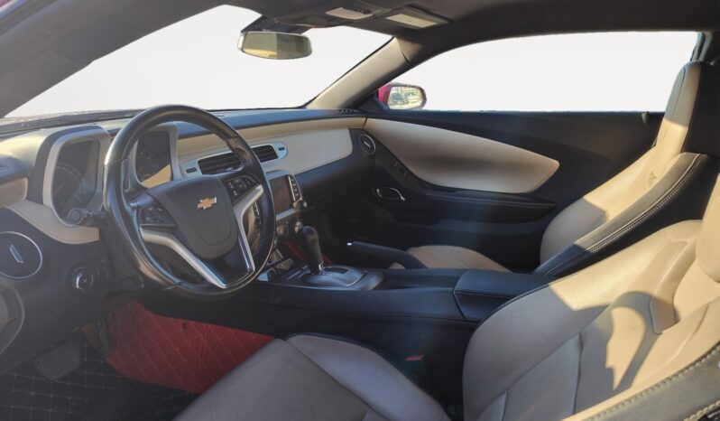 Interior view of a 2014 Chevrolet Camaro 2LT featuring a stylish dashboard, beige and black leather seats, and modern controls, highlighting the vehicle's luxury and performance attributes.