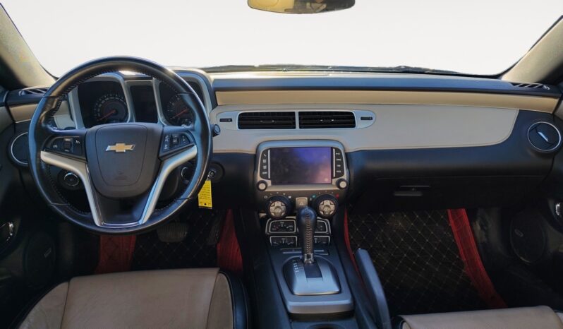 Chevrolet Camaro 2LT interior featuring a leather-wrapped steering wheel, touchscreen display, and stylish beige and black upholstery, highlighting luxury and performance.