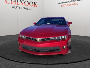 Red Chevrolet Camaro in front view, showcased at Chinook Auto Sales, highlighting sleek design and dealership branding.