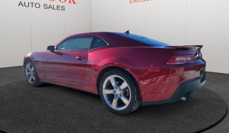 2014 Chevrolet Camaro 2LT in red, showcasing sleek coupe design and alloy wheels, parked at Chinook Auto Sales, highlighting its sporty rear profile and modern aesthetics.