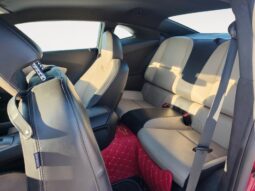 Interior view of a 2014 Chevrolet Camaro 2LT showcasing beige and black seating in the rear row, emphasizing spaciousness and comfort for passengers.