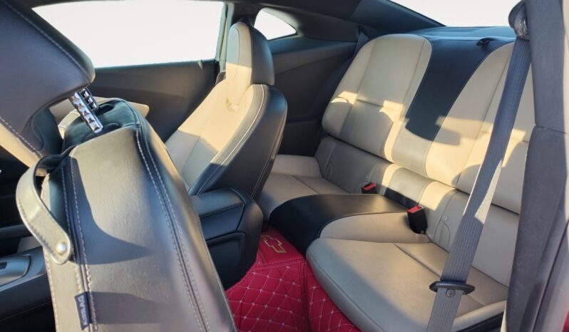 Interior view of a 2014 Chevrolet Camaro 2LT showcasing beige leather seats and a black leather seatback, highlighting the sporty design and comfort features.