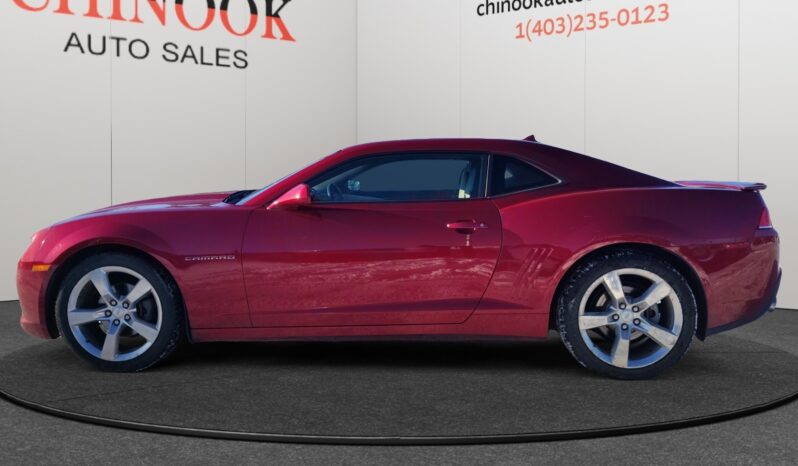 2014 Chevrolet Camaro 2LT in red, showcasing a sleek coupe design with a dynamic profile, displayed against a neutral background from Chinook Auto Sales.