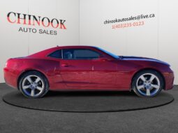 2014 Chevrolet Camaro 2LT in red, showcasing sleek coupe design and chrome wheels, featured at Chinook Auto Sales.