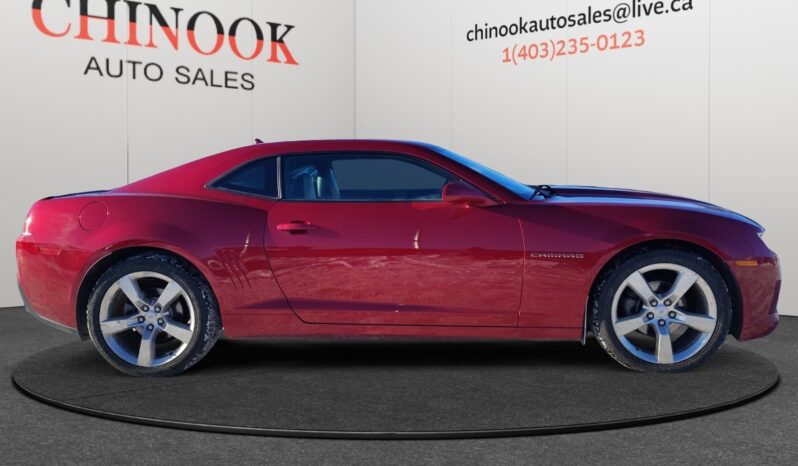 2014 Chevrolet Camaro 2LT in red, side view highlighting sleek coupe design and alloy wheels, showcased at Chinook Auto Sales.