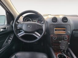 Interior view of a 2010 Mercedes-Benz GL350 Diesel featuring a leather steering wheel, dashboard controls, and a center console with audio system and climate controls.