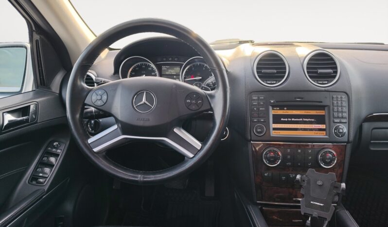 2010 Mercedes-Benz GL350 Diesel interior view showcasing steering wheel, dashboard controls, and infotainment system features.