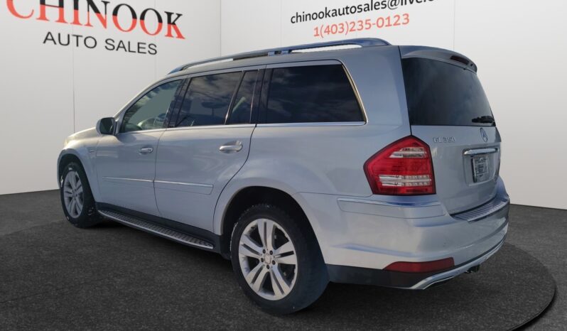 2010 Mercedes-Benz GL350 Diesel in silver, showcasing rear-left view with dealership branding from Chinook Auto Sales in the background.