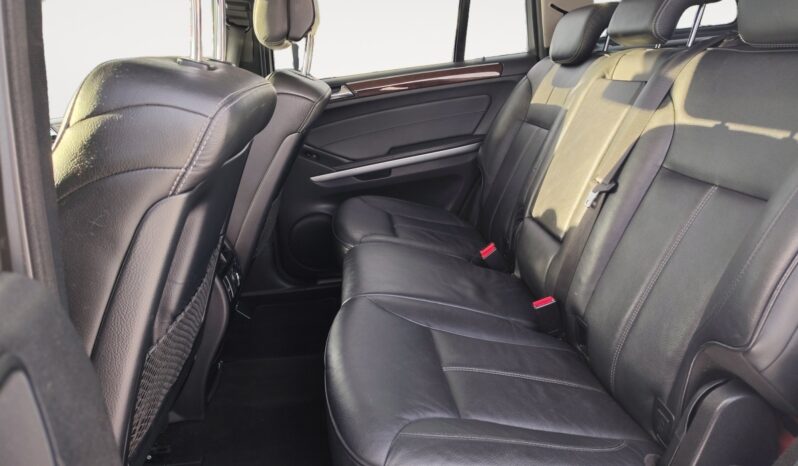 Interior view of the 2010 Mercedes-Benz GL350 Diesel's rear seating area, featuring black leather upholstery, spacious seating for passengers, and a refined cabin design.