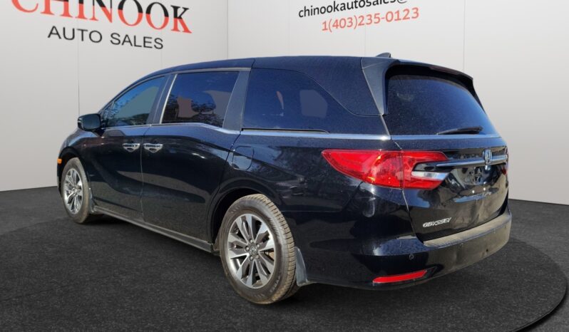2022 Honda Odyssey EX-L in black, showcasing rear left side view, parked at Chinook Auto Sales, emphasizing family-friendly design and spacious body.