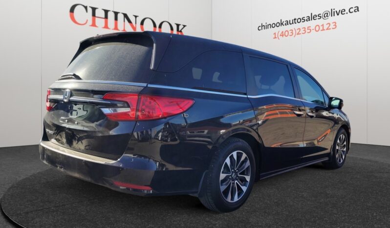 2022 Honda Odyssey EX-L in black, showcasing rear and side view, displayed against Chinook Auto Sales branding, highlighting family-friendly features and spacious design.