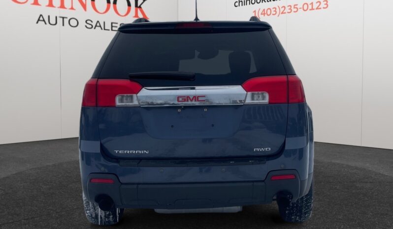 2014 GMC Terrain SLT in Deep Blue Pearl, rear view, showcasing the GMC logo and "Terrain AWD" badge, set against a neutral background with Chinook Auto Sales branding.