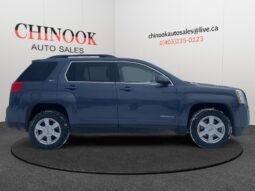 2014 GMC Terrain SLT in Deep Blue Pearl, side view, showcasing family SUV design, available for CAD $9,995 at Chinook Auto Sales, Calgary.