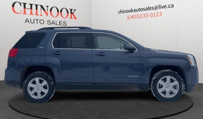 2014 GMC Terrain SLT SUV in Deep Blue Pearl, showcasing side profile with dealership branding from Chinook Auto Sales, emphasizing family-friendly features and compact design.