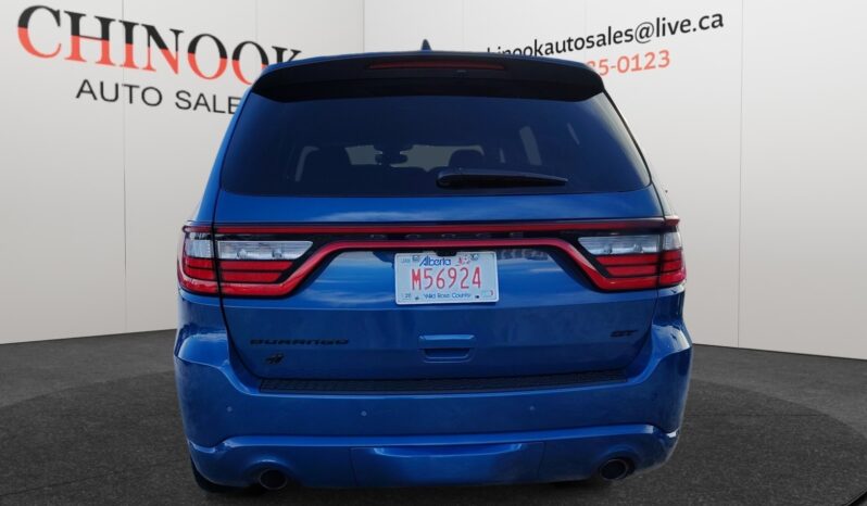 2023 Dodge Durango GT AWD in blue, showcasing rear view with distinctive taillights and dealership branding, emphasizing its SUV design and performance features.