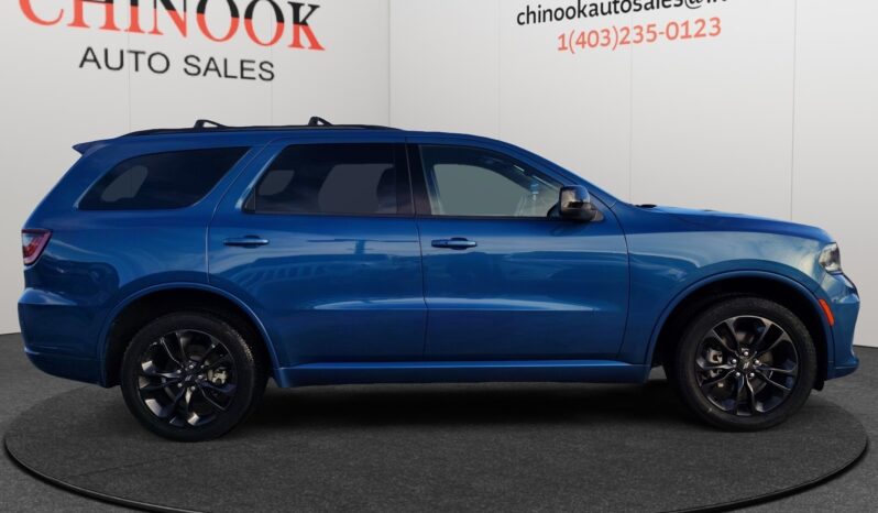2023 Dodge Durango GT AWD in blue, showcasing side profile with premium wheels, set against a neutral background, emphasizing its SUV design and suitability for Calgary driving conditions.