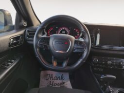 Interior view of a 2023 Dodge Durango GT AWD steering wheel and dashboard, featuring instrument panel and controls, highlighting premium features and design for enhanced driving experience.