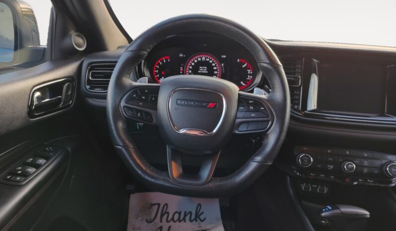 Dodge steering wheel and dashboard interior of 2023 Dodge Durango GT AWD, showcasing advanced controls and instrumentation, emphasizing performance and user experience.