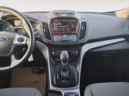 Ford Escape SE interior view showcasing center console, touchscreen display, gear shift, and gray upholstery, emphasizing modern features and design for a 2015 used SUV.