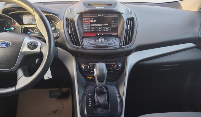 Ford Escape SE interior featuring center console, infotainment display, and gear shifter, highlighting user-friendly controls and modern design.