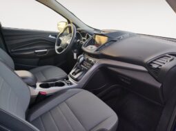 Interior view of a 2015 Ford Escape SE showcasing gray seating, dashboard controls, and steering wheel, highlighting comfort and functionality for potential buyers.