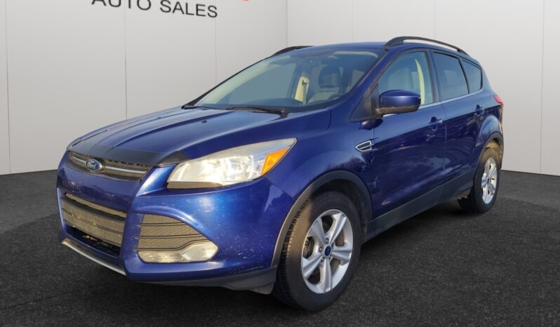 2015 Ford Escape SE in blue, showcasing front-left view with clean lines and modern design, featuring Ford logo and Chinook Auto Sales branding in the background.