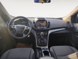 Interior view of a 2015 Ford Escape SE showcasing dashboard, steering wheel, and center console features, designed for comfort and utility in a compact SUV.