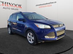 2015 Ford Escape SE in blue, showcasing a compact SUV design, prominently displayed at Chinook Auto Sales, emphasizing affordability and financing options.