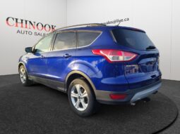 2015 Ford Escape SE in blue, showcasing rear-left view, displayed at Chinook Auto Sales, emphasizing its compact SUV design and features for Calgary drivers.