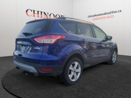 2015 Ford Escape SE in blue, showcasing rear and right side, displayed at Chinook Auto Sales, emphasizing its compact SUV design and suitability for Calgary roads.
