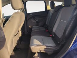 Interior view of the rear seating area in a 2015 Ford Escape SE, featuring gray upholstery and ample space, highlighting comfort and versatility for passengers.