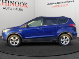 2015 Ford Escape SE in blue, side view, showcasing SUV design and features, available for sale at Chinook Auto Sales, highlighting pre-qualification for financing options.