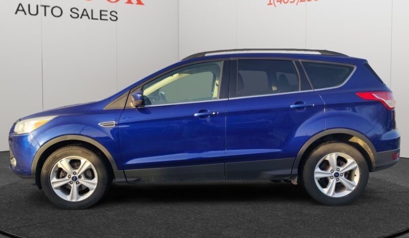 2015 Ford Escape SE in blue, side view, showcasing SUV design and features, available at Chinook Auto Sales for CAD $8,998.