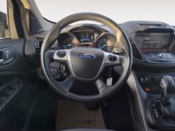 Ford Escape SE steering wheel and dashboard interior, showcasing vehicle controls and instrument panel features for the 2015 model.